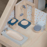 The PlanToys Bathroom Dolls House Furniture set placed in a wooden dolls house. 