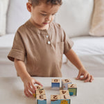 PlanToy plastic-free Waldorf blocks stacked in a pyramid showing counting dots from numbers 1-9 on the front