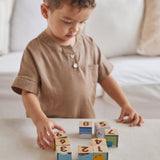 PlanToy plastic-free Waldorf blocks stacked in a pyramid showing counting dots from numbers 1-9 on the front