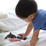 A close up of a child playing with the PlanToys Sea Life Set. 