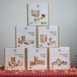 Six boxes of PlanToys natural wooden dollhouse furniture, stacked in a large discounted bundle at Babipur. 