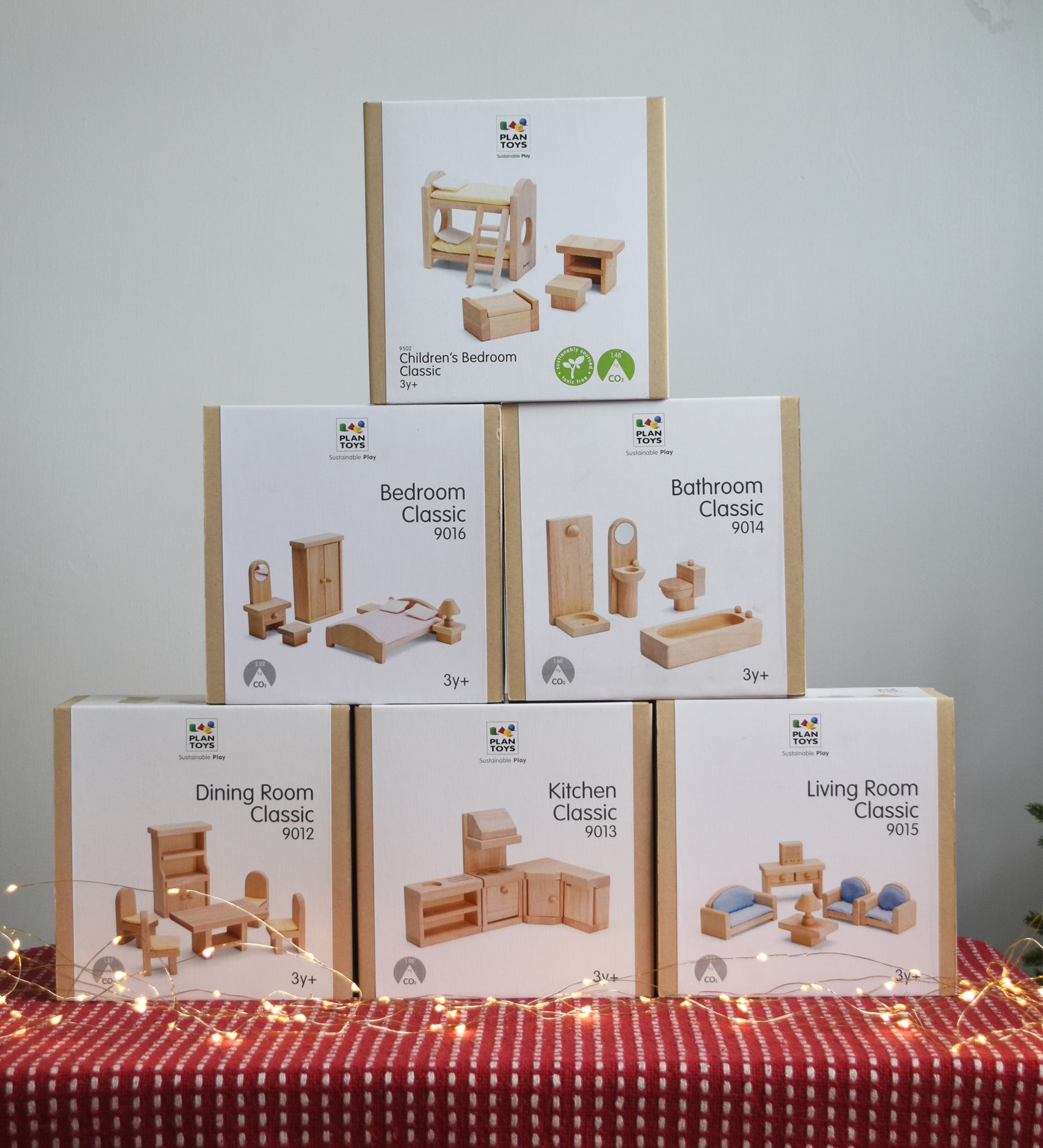 Six boxes of PlanToys natural wooden dollhouse furniture, stacked in a large discounted bundle at Babipur. 