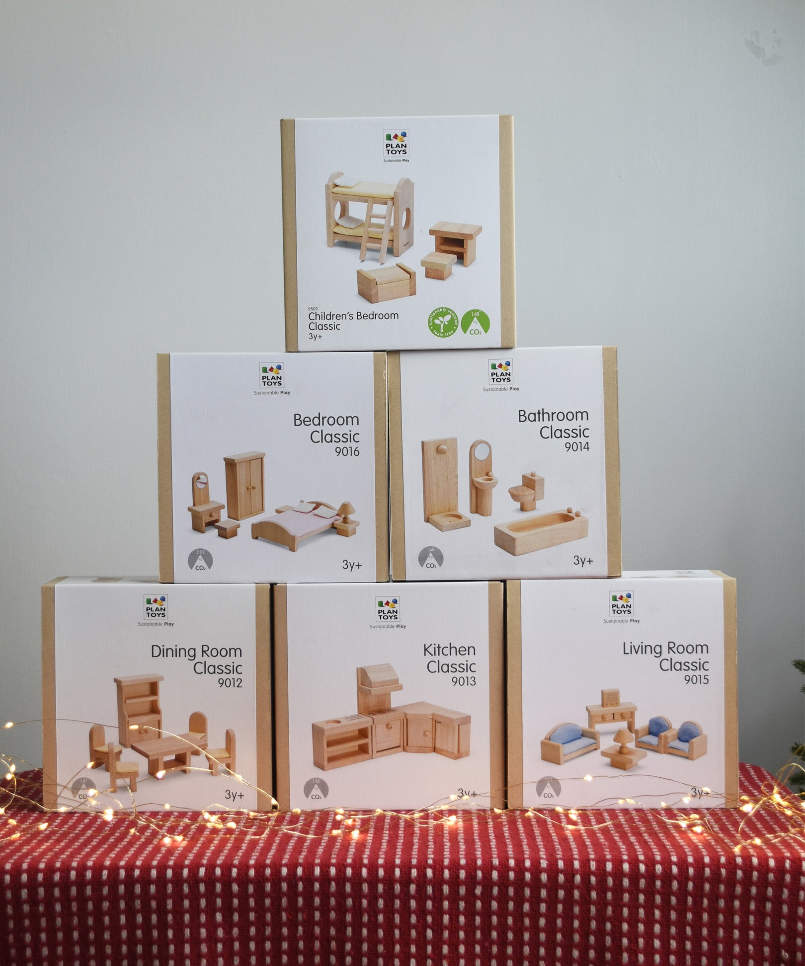 Six boxes of PlanToys natural wooden dollhouse furniture, stacked in a large discounted bundle at Babipur. 