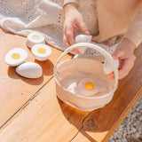 Child holding a Plantoys wooden play egg above a fabric basket on a wooden bench