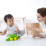 Mother and baby playing together with the Plan Toys Dancing Alligator wooden pull along toy