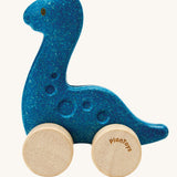 A PlanToys Diplo Dino wooden Car toy. A blue coloured diplodocus dinosaur on wheels. PlanToys range of toys are made from sustainably sourced rubberwood, we're proud stockists of PlanToys here at Babipur. 
