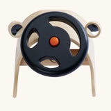 PlanToys Driving Console wooden toy. Black steering wheel with orange button in the middle on a wooden dashboards with wing mirrors.