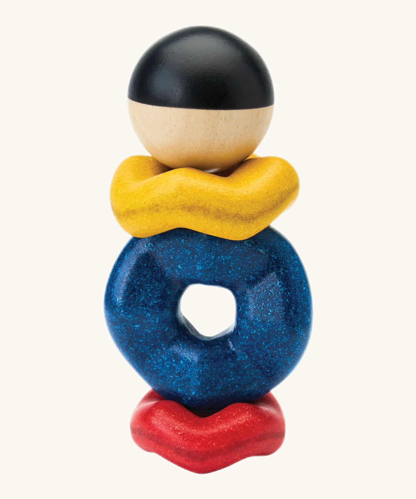 Baby crawling across a rug towards the wave stacking toy