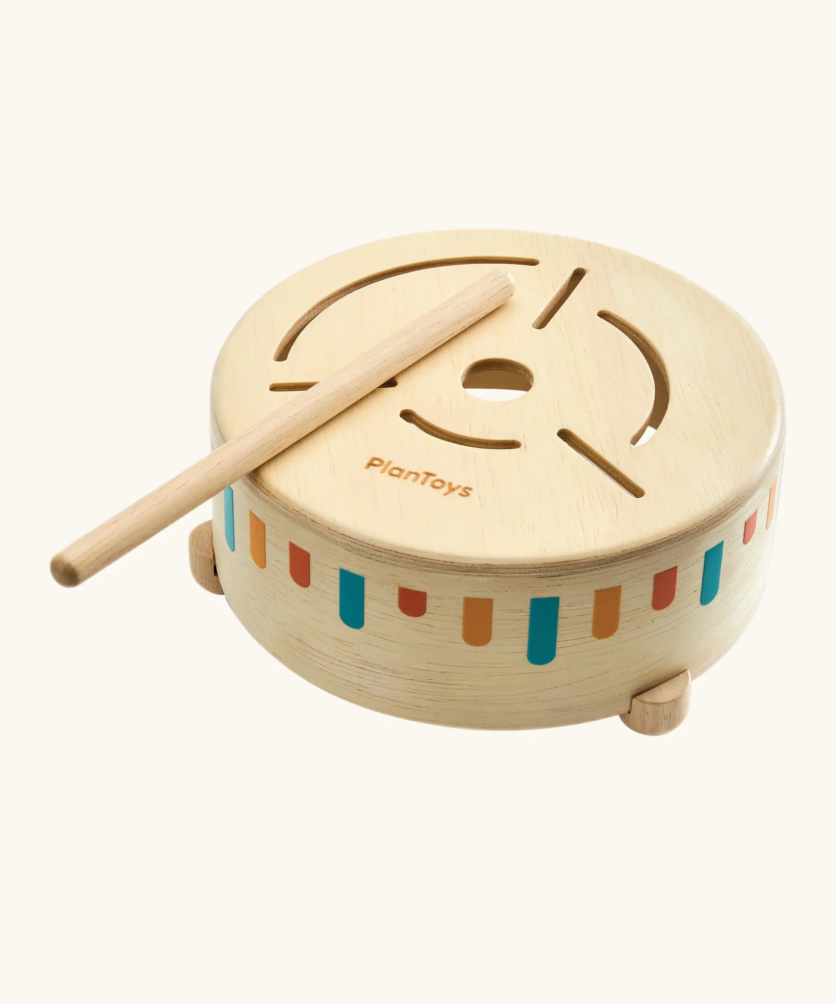 Overhead view of a toddler drumming with the wooden mallet