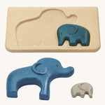 The PlanToys Elephant Puzzle on a plain background. The largest and smallest elephants have been taken out of the puzzle base. 