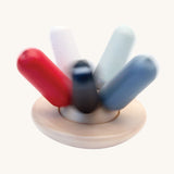 A PlanToys Flexi Jellyfish wooden high contrast baby toy shown in motion spinning. A wooden top with high contrast, white, greys, black and red flexible wooden pieces for the jellyfish legs. PlanToys range of toys are made from sustainably sourced rubberwood, we're proud stockists of PlanToys here at Babipur. 