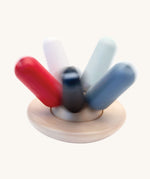 A PlanToys Flexi Jellyfish wooden high contrast baby toy shown in motion spinning. A wooden top with high contrast, white, greys, black and red flexible wooden pieces for the jellyfish legs. PlanToys range of toys are made from sustainably sourced rubberwood, we're proud stockists of PlanToys here at Babipur. 