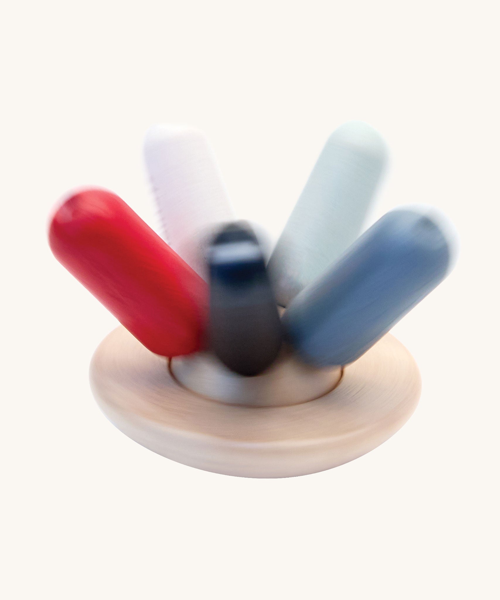 A PlanToys Flexi Jellyfish wooden high contrast baby toy shown in motion spinning. A wooden top with high contrast, white, greys, black and red flexible wooden pieces for the jellyfish legs. PlanToys range of toys are made from sustainably sourced rubberwood, we're proud stockists of PlanToys here at Babipur. 