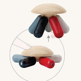 PlanToys Flexi Jellyfish wooden high contrast baby toy. A wooden top with high contrast, white, greys, black and red flexible wooden pieces for the jellyfish legs. PlanToys range of toys are made from sustainably sourced rubberwood, we're proud stockists of PlanToys here at Babipur. 