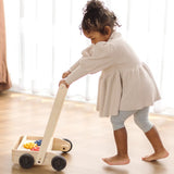 Child pushing the PlanToys gear & go push along wooden baby walker. 