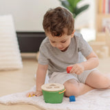 Child playing with the PlanToys geo sorting bucket wooden shape sorting toy. 