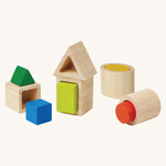 The PlanToys wooden Geo shapes Matching Blocks on a plain background. The blocks are shown out of their packaging. 
