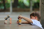 A child playing with the PlanToys Geo Stacking Rocks. They are stacking the rocks on top of each other. 