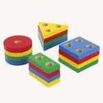 The rainbow coloured shapes from the PlanToys Geometric Sorting Board set. 