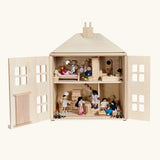 PlanToys wooden Georgian dollhouse children's toy. Front door are open and the rooms inside have been filled with wooden dolls house furniture and wooden dolls. 