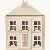 PlanToys wooden Georgian dollhouse children's toy.  Dolls can be seen inside. 