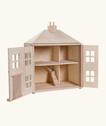 PlanToys wooden Georgian dollhouse children's toy shown with the front walls opened. 