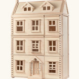 PlanToys Grand Victorian Dollhouse with thee floors and an attic level.