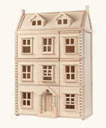 PlanToys Grand Victorian Dollhouse with thee floors and an attic level.