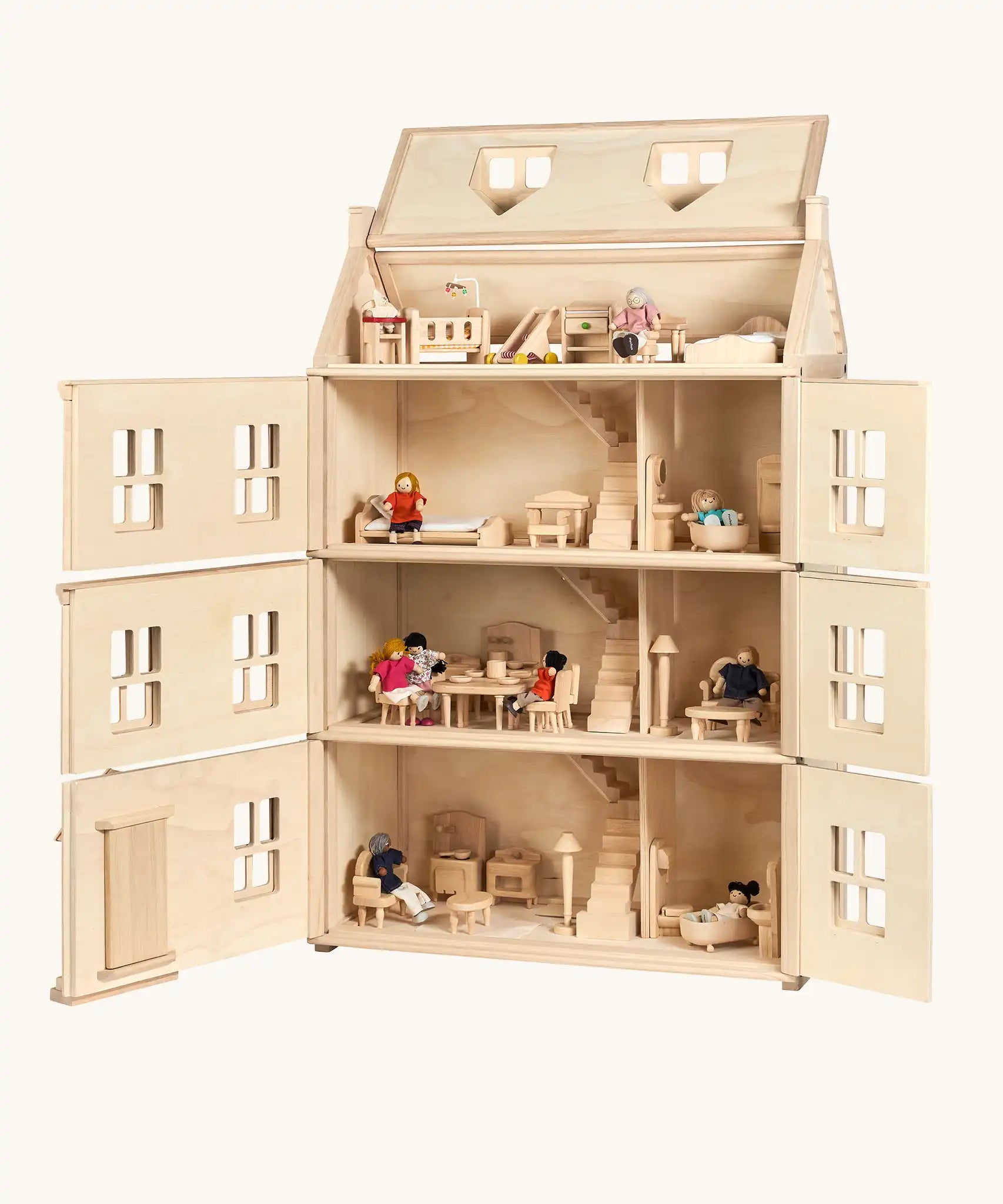 PlanToys Grand Victorian Dollhouse shown with front and roof open. All floors and attic room has PlanToys dolls house furniture inside.