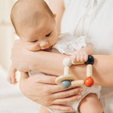 A baby clutching onto the PlanToys high contrast square clutching toy. PlanToys range of toys are made from sustainably sourced rubberwood, we're proud stockists of PlanToys here at Babipur. 