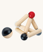 PlanToys high contrast Triangle baby Clutching Toy. A black and natural wood wooden ball with stretchy wooden triangle clutching toy. PlanToys range of toys are made from sustainably sourced rubberwood, we're proud stockists of PlanToys here at Babipur. 