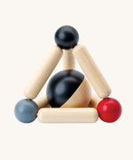 PlanToys high contrast Triangle baby Clutching Toy. A black and natural wood wooden ball in a stretchy triangle clutching toy. PlanToys range of toys are made from sustainably sourced rubberwood, we're proud stockists of PlanToys here at Babipur. 