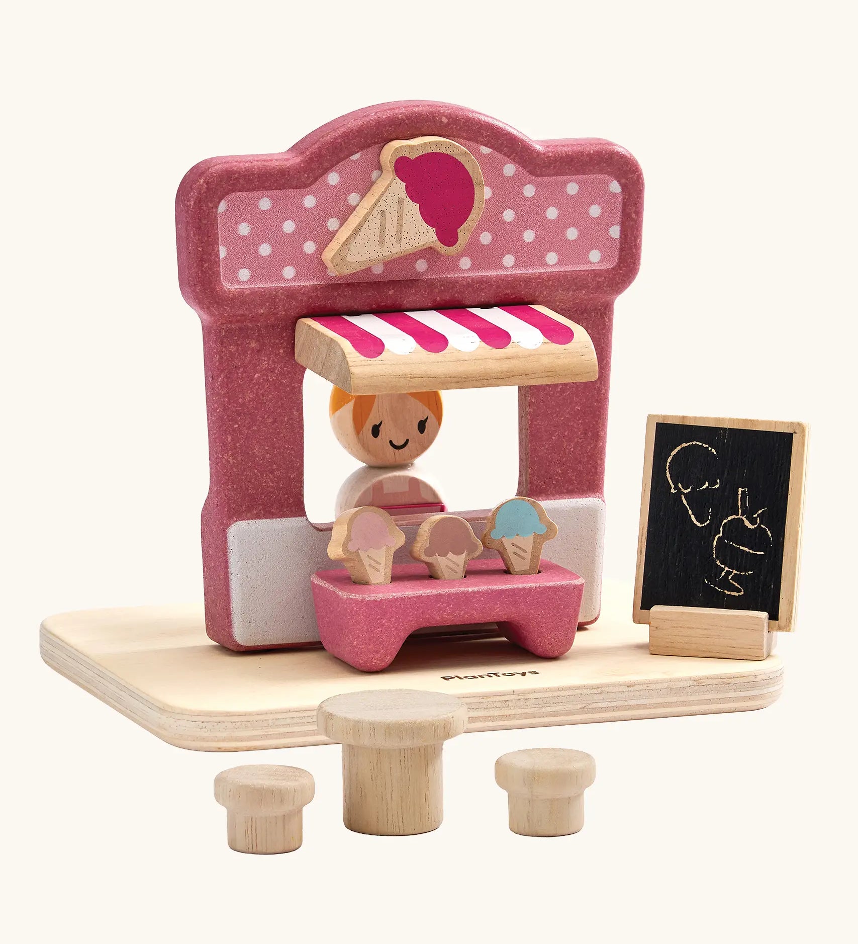 PlanToys ice cream shop wooden toy playset. Pink wooden shop with three ice cream cones, advert board, table and two seats and a worker figure.