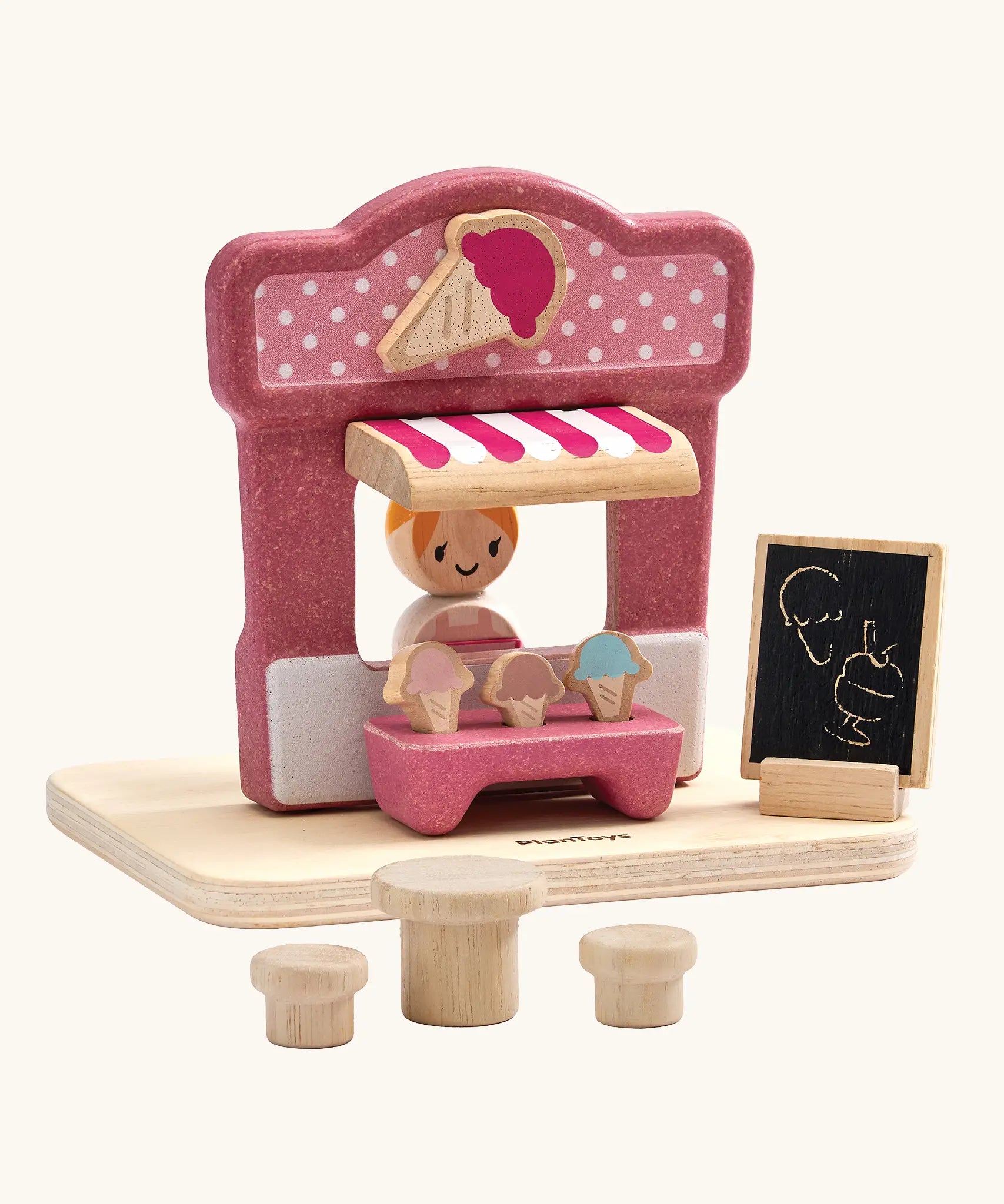 PlanToys ice cream shop wooden toy playset. Pink wooden shop with three ice cream cones, advert board, table and two seats and a worker figure.