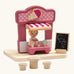 PlanToys ice cream shop wooden toy playset. Pink wooden shop with three ice cream cones, advert board, table and two seats and a worker figure.