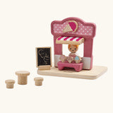 PlanToys ice cream shop wooden toy playset. Pink wooden shop with three ice cream cones, advert board, table and two seats and a worker figure.
