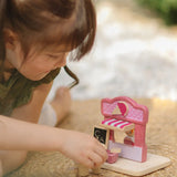 Child playing with the PlanToys ice cream shop wooden toy playset.