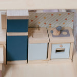 A close up of the PlanToys Kitchen Dolls House Furniture set
placed inside a dolls house.