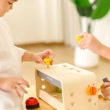 Children playing with the PlanToys little tool bench set.