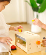 Children playing with the PlanToys little tool bench set.