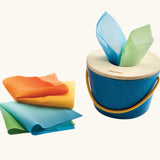 Baby grasping the wooden lid of the tissue box toy