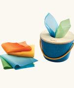 Baby grasping the wooden lid of the tissue box toy