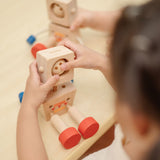 A child playing with the PlanToys Mood Bot Emotions Wooden Toy Robot. PlanToys range of toys are made from sustainably sourced rubberwood, we're proud stockists of PlanToys here at Babipur. 