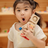 A child holding onto the PlanToys Mood Bot Emotions Wooden Toy Robot. PlanToys range of toys are made from sustainably sourced rubberwood, we're proud stockists of PlanToys here at Babipur. 