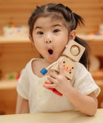 A child holding onto the PlanToys Mood Bot Emotions Wooden Toy Robot. PlanToys range of toys are made from sustainably sourced rubberwood, we're proud stockists of PlanToys here at Babipur. 
