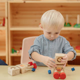 A child sitting at a table playing with the  PlanToys Mood Bot Emotions Wooden Toy Robot. PlanToys range of toys are made from sustainably sourced rubberwood, we're proud stockists of PlanToys here at Babipur. 
