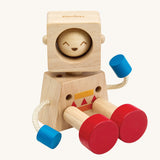 A PlanToys Mood Bot Emotions Wooden Toy Robot in a seated position. PlanToys range of toys are made from sustainably sourced rubberwood, we're proud stockists of PlanToys here at Babipur. 