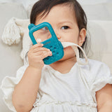 A child holding up a PlanToys My First Phone showing the blue side. The child is looking through the phone's screen which is a magnifier. 