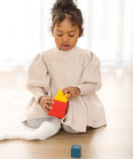 Child playing with the PlanToys nesting boxes.