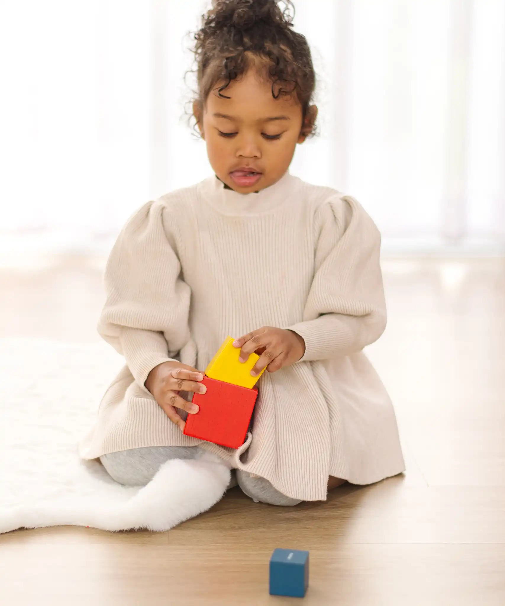 Child playing with the PlanToys nesting boxes.